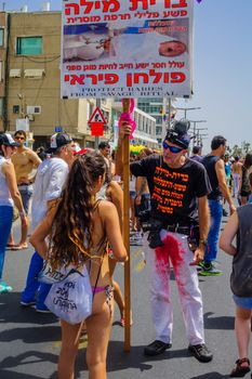 TEL-AVIV, ISRAEL - JUNE 03, 2016: A protestor against circumcision speaks to the crowd, in the Pride Parade in the streets of Tel-Aviv, Israel. Its part of an annual event of the LGBT community