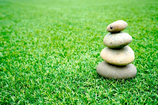 stones stacked up on grass