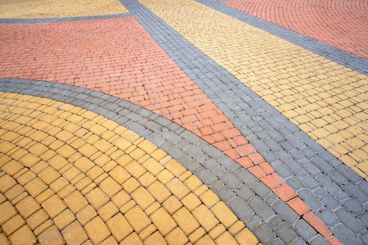 Detail of a nice artistic colorful cobblestones pavement in the Natalka park of Kiev, Ukraine