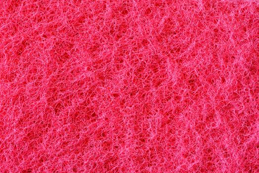 Macro of pink synthetic sponge texture, scrub side