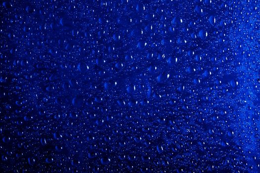 Many water drops on a dark blue background