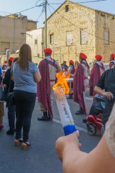 Haifa, Israel - April 27, 2019: Holy fire being held, and scouts perform a Holy Saturday parade, part of Orthodox Easter celebration in Haifa, Israel