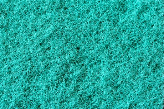 Macro of green synthetic sponge texture, scrub side
