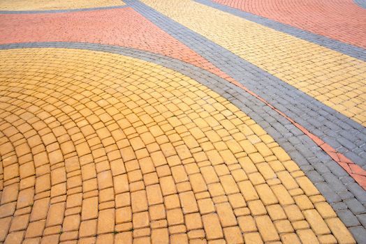Detail of a nice artistic colorful cobblestones pavement in the Natalka park of Kiev, Ukraine