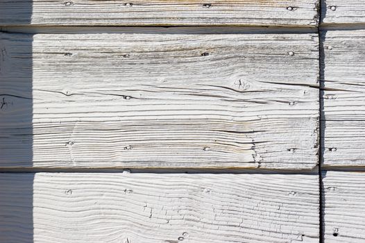 Close up of the texture of a pine planks door painted in white