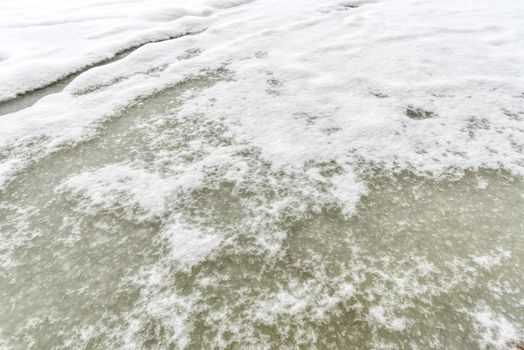 Detail of snow and ice on the frozen Dnieper river in Kiev, Ukraine