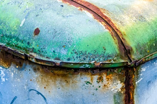 Texture of colored rust metal on an old car