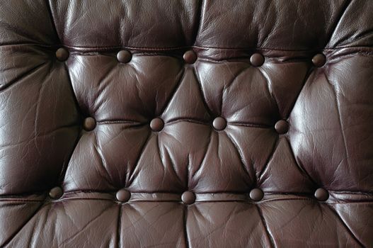 A detail of an old leather couch