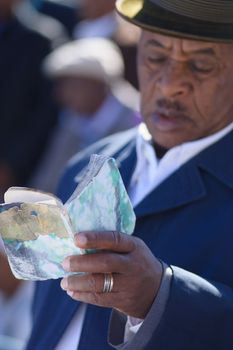 JERUSALEM - NOV 20, 2014: An Ethiopian Jewish man prays using a prayer book at the Sigd, in Jerusalem, Israel. The Sigd is an annual holiday of the Ethiopian Jews