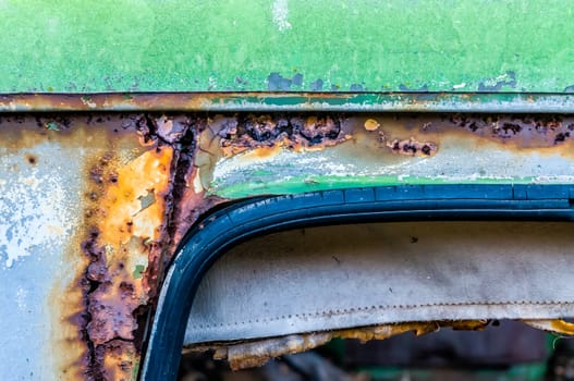 Texture of colored rust metal on an old car