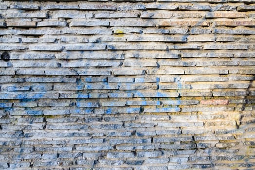 Stone wall texture under a changing light