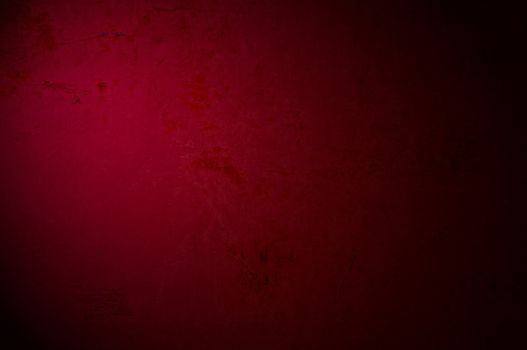 An antique dark red texture with light effect, to be used as background with images or light colored text.