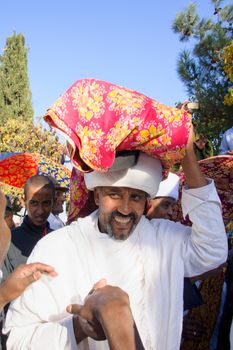 JERUSALEM - NOV 20, 2014: A Kes, religious leader of the Ethiopian Jews, carrying a wrapped holy prayer book, at the end of the annual Sigd holiday prays, in Jerusalem, Israel