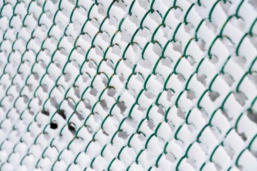 Wire fence with snow in cold winter