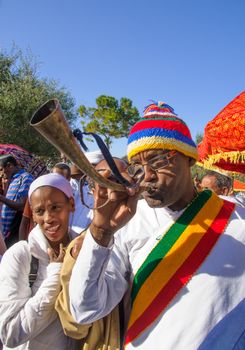 JERUSALEM - NOV 20, 2014: A Kes, religious leader of the Ethiopian Jews, plays a shofar to mark the end of the Sigd prays, in Jerusalem, Israel. The Sigd is an annual holiday of the Ethiopian Jews