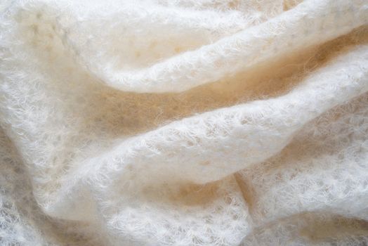 Soft folds of a white goat fluff scarf to be used as background