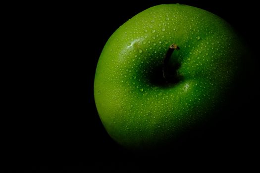 detail fresh green Apple with water droplet isolated on black background – low key macro shoot