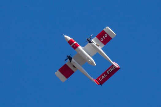 Winchester, CA USA - June 14, 2020: Cal Fire aircraft preparingto drop fire retardant on a dry hilltop wildfire near Winchester, California.