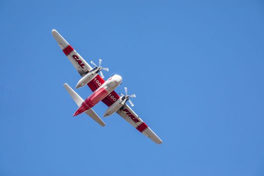 Winchester, CA USA - June 14, 2020: Cal Fire aircraft preparingto drop fire retardant on a dry hilltop wildfire near Winchester, California.