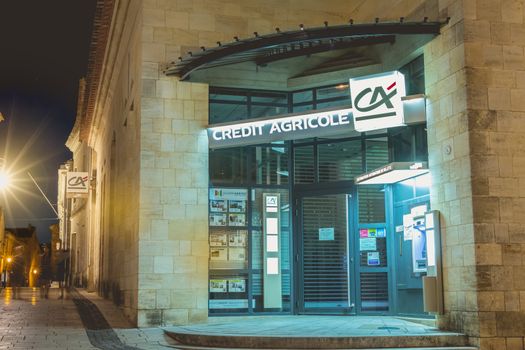 SAINT EMILION, FRANCE - May 25, 2017 : architectural detail of a Credit Agricole bank branch at night during the spring