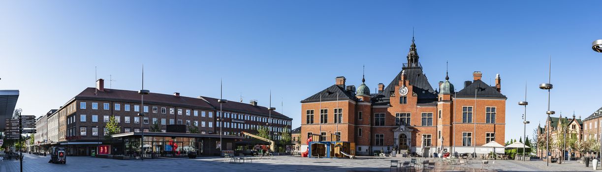 UMEA, SWEDEN - JUNE 10, 2020: Scenic panorama of central square in Umea city - Town Hall on Radhustorget - nice mixture of old architecture. Early sunny summer day, no people, Vasterbotten