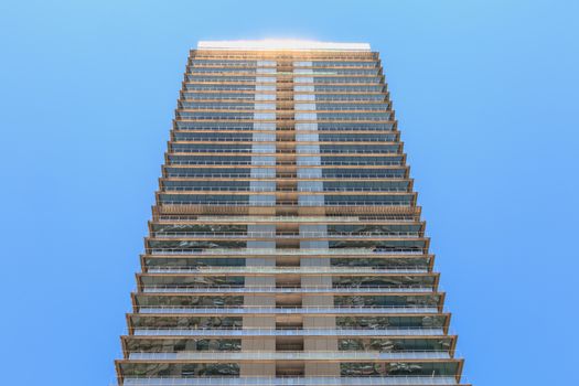 BARCELONA, SPAIN - June 21, 2017 : architectural detail of the MAPFRE tower during the summer, a skyscraper designed by the architects Inigo and Enrique de Leon and built for the 1992 Summer Olympics