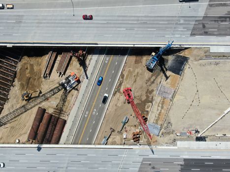 Aerial view of highway bridge construction over small river, San Diego, California, USA