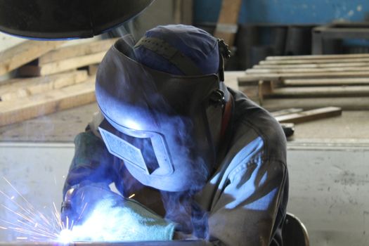 Welder performs welding work semi-automatic electric arc welding. MIG welding.