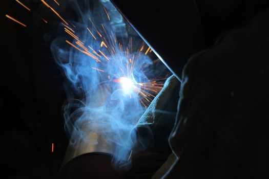 Metal welding. Sparks from electric heating. Iron, materials.Artistic welding sparks light, industrial background .