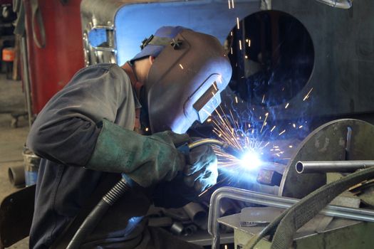 Welder performs welding work semi-automatic electric arc welding. MIG welding.