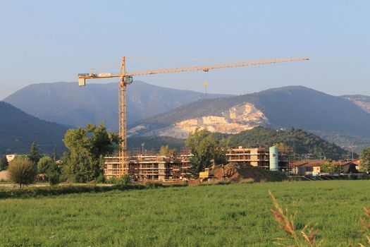 house under construction with mountains in background