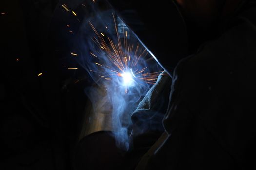 Metal welding. Sparks from electric heating. Iron, materials.Artistic welding sparks light, industrial background .