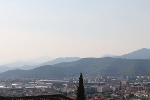 Aerial panoramic view of old historical city centre of Brescia city with churches, towers and medieval buildings with red tiled roofs, Lombardy, Northern Italy. Cityscape of Brescia town.