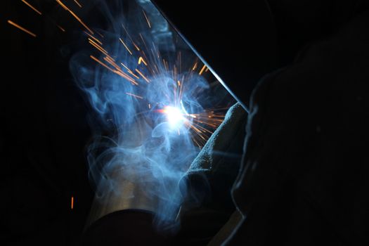 Metal welding. Sparks from electric heating. Iron, materials.Artistic welding sparks light, industrial background .