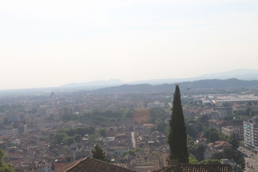 Aerial panoramic view of old historical city centre of Brescia city with churches, towers and medieval buildings with red tiled roofs, Lombardy, Northern Italy. Cityscape of Brescia town.