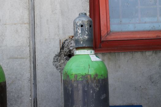 Gas cylinder for welder placed at the construction site.