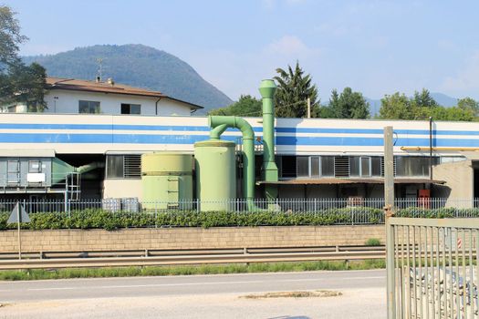 Modern facade of an industrial building in front of a blue sky