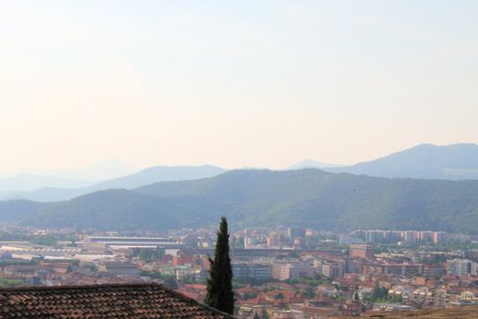 Aerial panoramic view of old historical city centre of Brescia city with churches, towers and medieval buildings with red tiled roofs, Lombardy, Northern Italy. Cityscape of Brescia town.