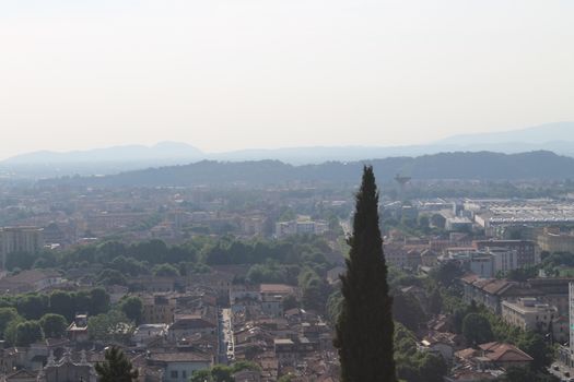 Aerial panoramic view of old historical city centre of Brescia city with churches, towers and medieval buildings with red tiled roofs, Lombardy, Northern Italy. Cityscape of Brescia town.