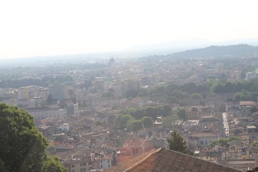 Aerial panoramic view of old historical city centre of Brescia city with churches, towers and medieval buildings with red tiled roofs, Lombardy, Northern Italy. Cityscape of Brescia town.