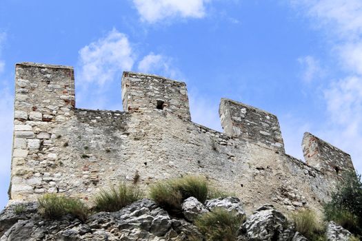 Ancient castle wall with tower in Malcesine on Garda Lake, Italy