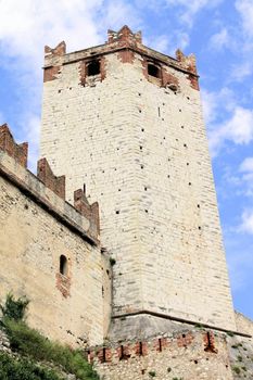 Ancient castle wall with tower in Malcesine on Garda Lake, Italy