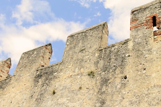 Ancient castle wall with tower in Malcesine on Garda Lake, Italy