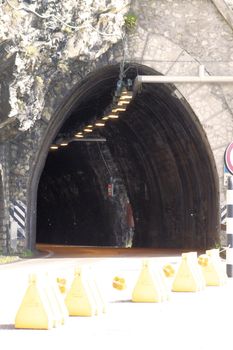 Scenic panoramic beltway road around lake Garda full of tunnels and galleries made in the rocks at the edge of a coastline