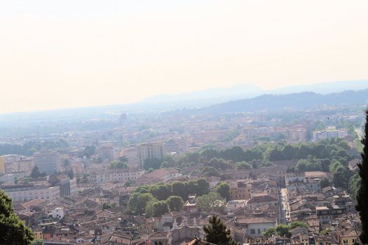 Aerial panoramic view of old historical city centre of Brescia city with churches, towers and medieval buildings with red tiled roofs, Lombardy, Northern Italy. Cityscape of Brescia town.