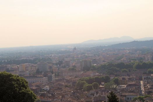 Aerial panoramic view of old historical city centre of Brescia city with churches, towers and medieval buildings with red tiled roofs, Lombardy, Northern Italy. Cityscape of Brescia town.