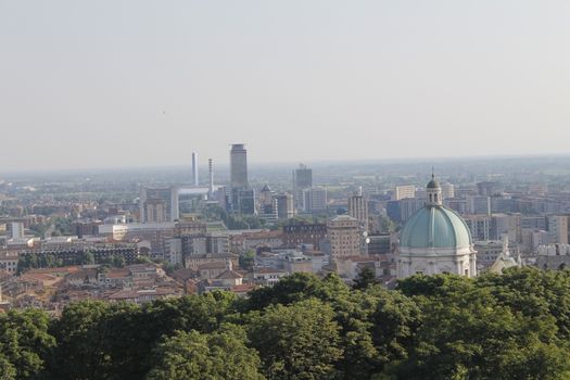 Aerial panoramic view of old historical city centre of Brescia city with churches, towers and medieval buildings with red tiled roofs, Lombardy, Northern Italy. Cityscape of Brescia town.