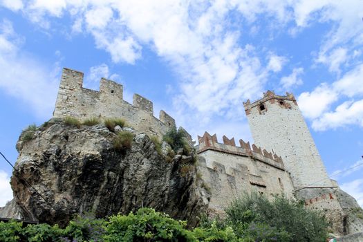 Ancient castle wall with tower in Malcesine on Garda Lake, Italy