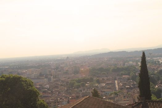 Aerial panoramic view of old historical city centre of Brescia city with churches, towers and medieval buildings with red tiled roofs, Lombardy, Northern Italy. Cityscape of Brescia town.