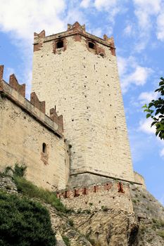 Ancient castle wall with tower in Malcesine on Garda Lake, Italy